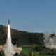 In this photo provided by Eighth U.S. Army, South Korea’s Hyunmoo Missile II, left, and U.S. MGM-140 Army Tactical Missile, right, are fired into the east sea during the combined military exercise against North Korea at an undisclosed location in South Korea, Wednesday, July 5, 2017 (Eighth U.S. Army via AP)